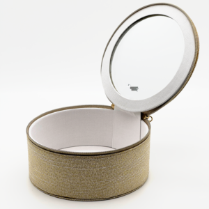 Open gold fabric jewelry box with built-in mirror, showing empty interior
