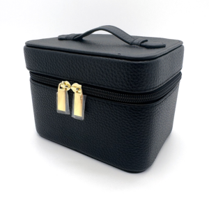 Black pebbled leather makeup case with gold zippers and top handle